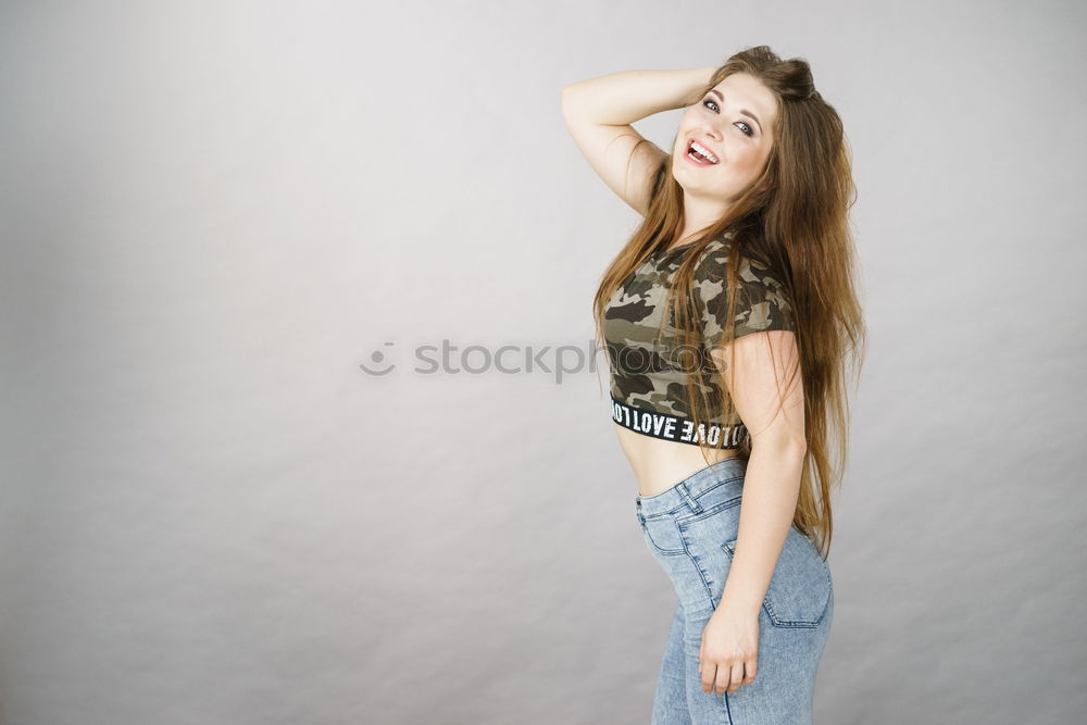 Similar – Image, Stock Photo Young athletic woman with long legs stands sideways in front of white wall and looks into camera