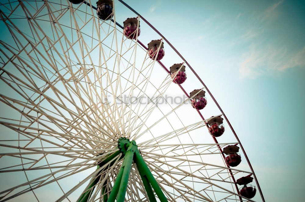 Similar – Bottom view of a ferris wheel against a clear sky