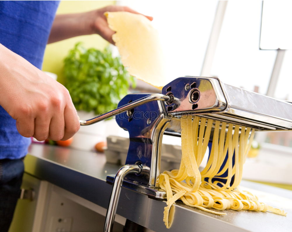 Similar – Image, Stock Photo Making homemade taglatelle with a pasta rolling cutter