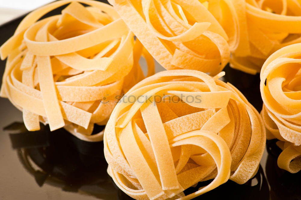 Similar – Raw tagliatelle on dark table