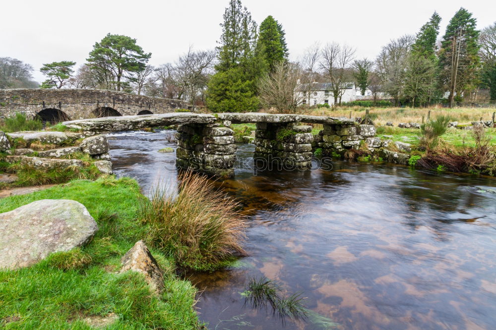 Woman sitting on a stone bridge in Dartmoor, England