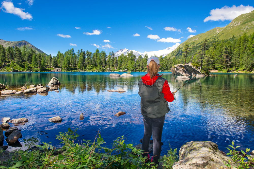 Similar – Mountain lake, woman standing