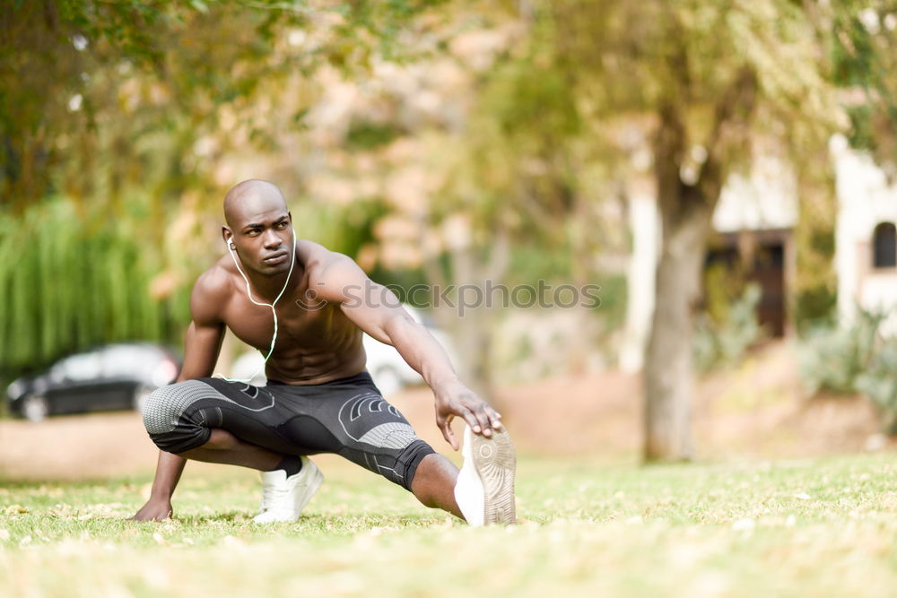 Athletic black man exercising at the park