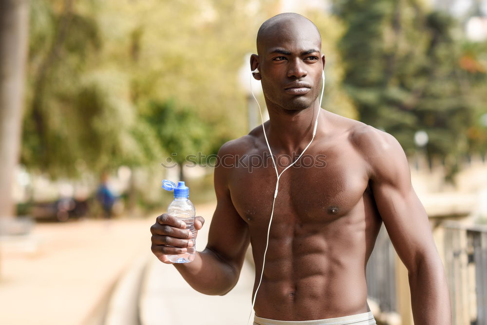 Similar – Young black man drinking water before running outdoors