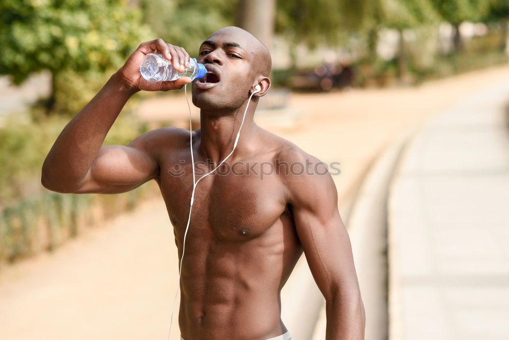 Similar – Young black man drinking water before running outdoors