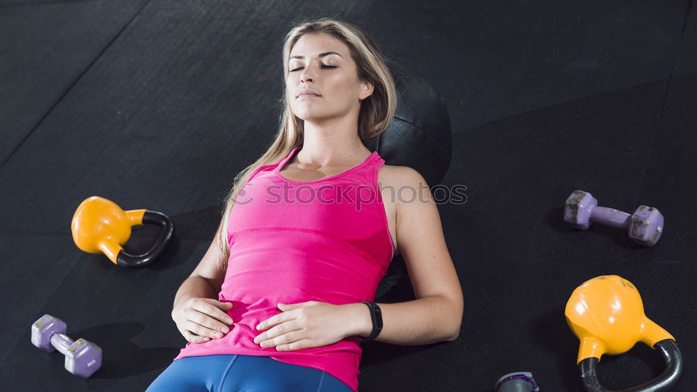 Woman doing exercises in aerobic class with a group on a fitness center