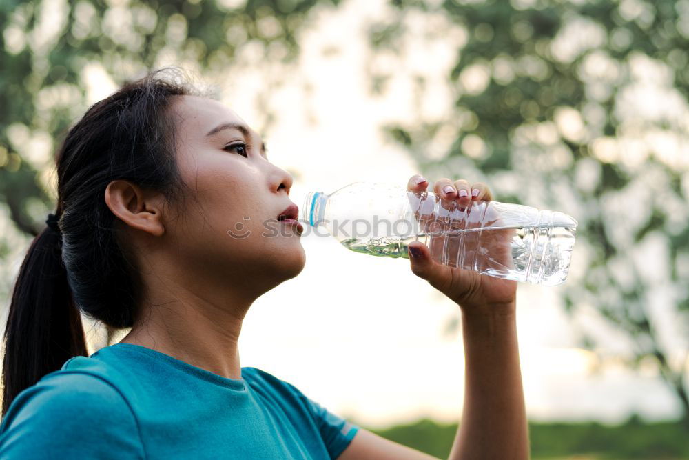 Similar – Young man drinking bottled water