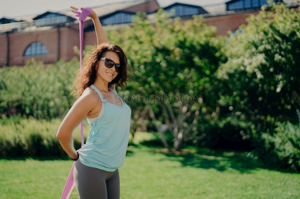 Similar – Image, Stock Photo Happy fit young woman does stretching workout on fitness mat practices yoga outside dressed in activewear has strong body breathes fresh air outdoor leads active lifestyle. Sport fitness concept