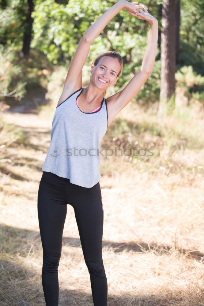 Similar – Woman stretching her body in front of ancient wall in park