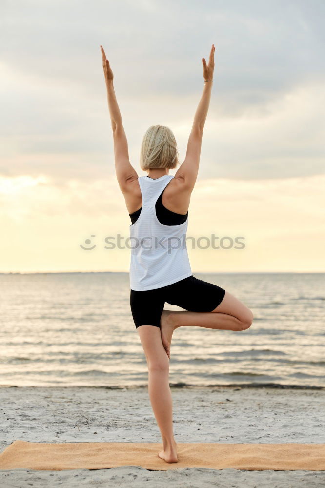 Similar – Rear view of young black woman doing yoga in the beach