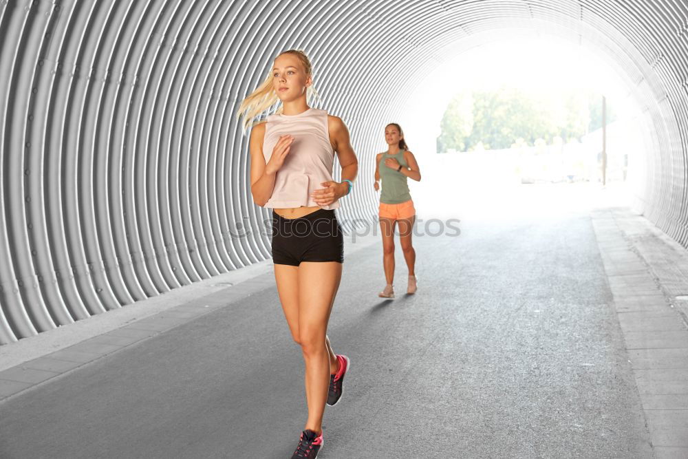 Similar – Young fitness woman runner running on city bridge.