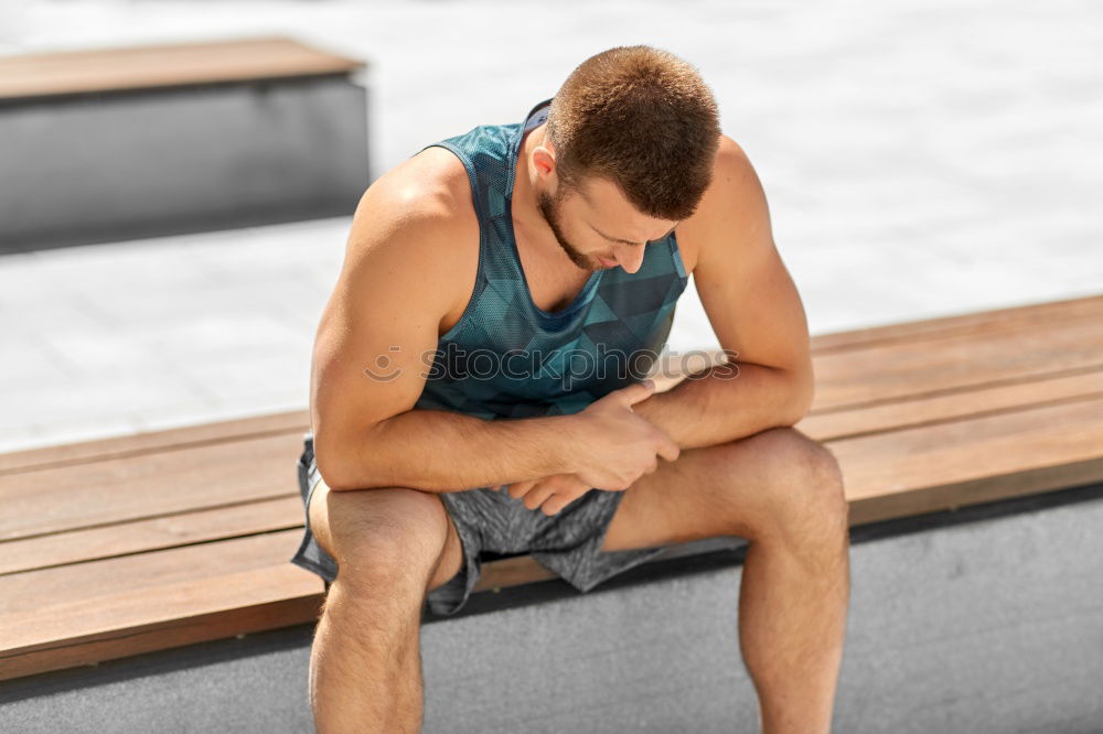 Similar – Sporty man sitting with towel and water bottle in gym floor