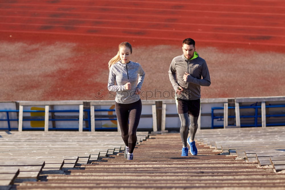 Similar – Image, Stock Photo Young couple running on a seafront promenade