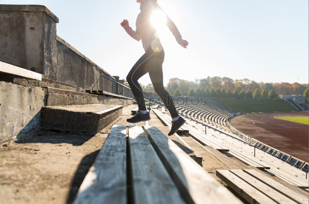 Similar – Young fitness woman runner running on city bridge.