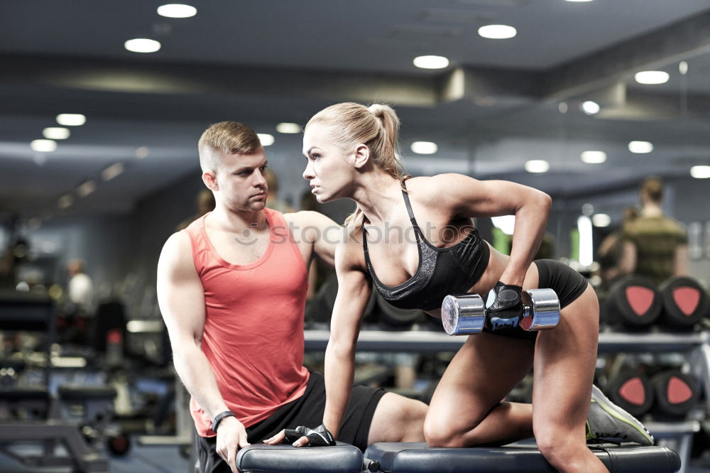 Similar – Personal trainer helping young woman lift weights