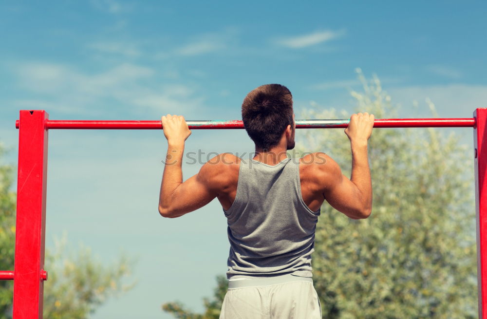 Similar – Athletischer junger Mann beim Vorbereiten und Kontrollieren von Gymnastikringen