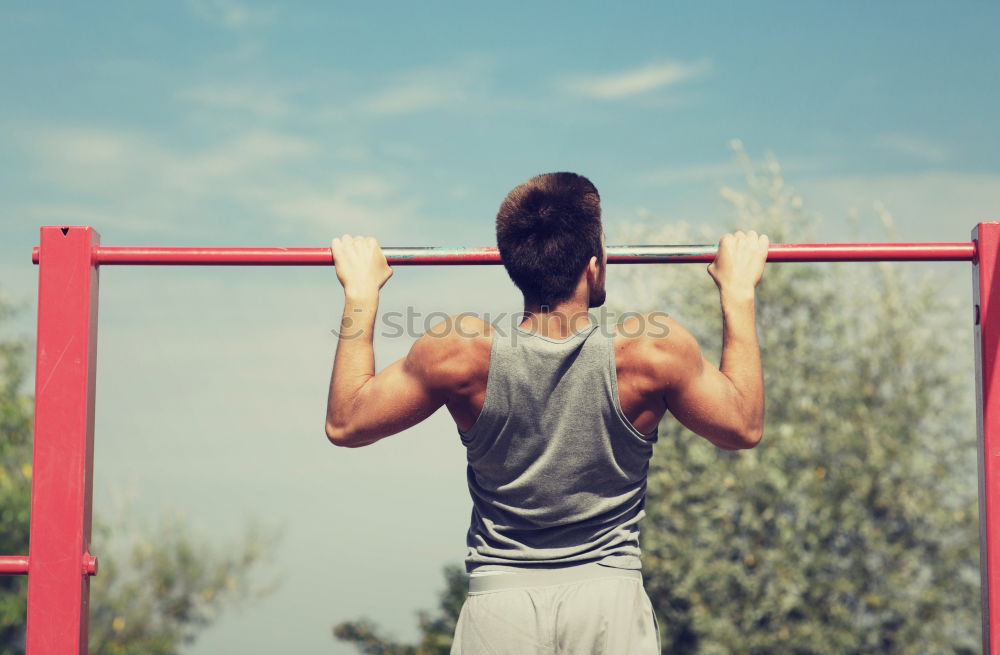 Similar – Athletischer junger Mann beim Vorbereiten und Kontrollieren von Gymnastikringen