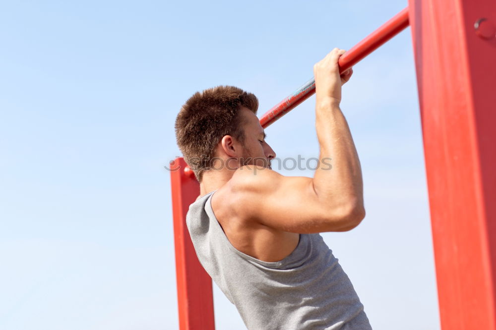 Young man stretching a resistance rubber band before calisthenics training