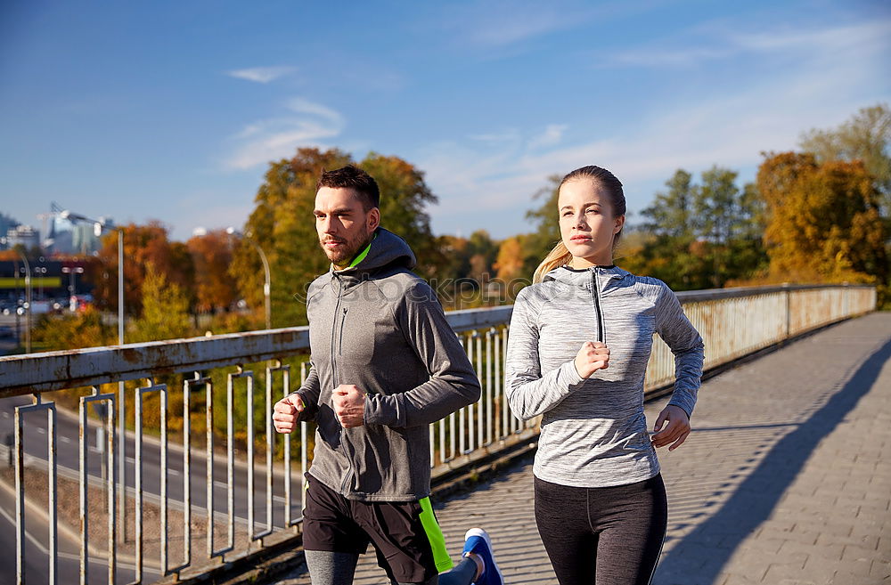 Similar – Young couple running on a seafront promenade