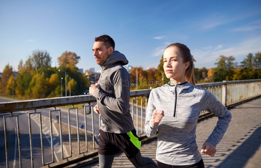 Similar – Active young couple jogging side by side in an urban street