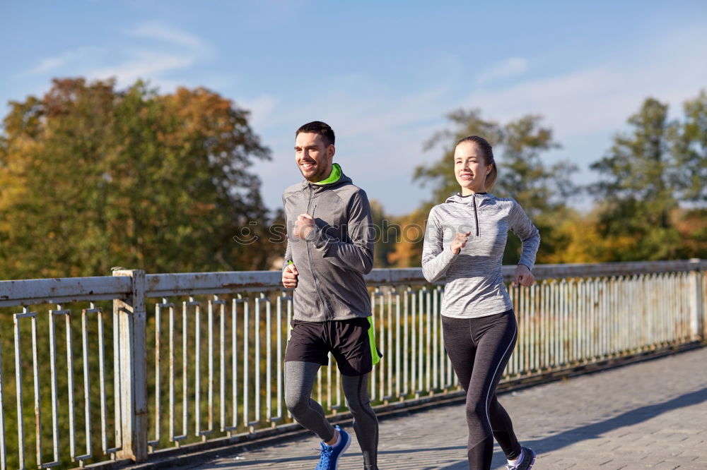 Similar – Active young couple jogging side by side in an urban street