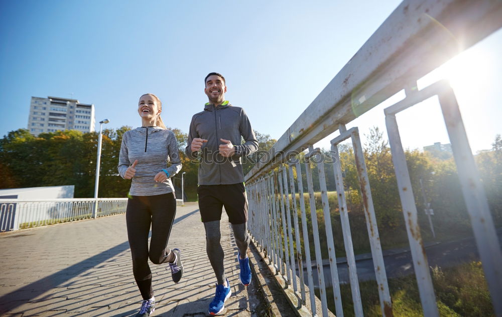 Similar – Young couple running on a seafront promenade