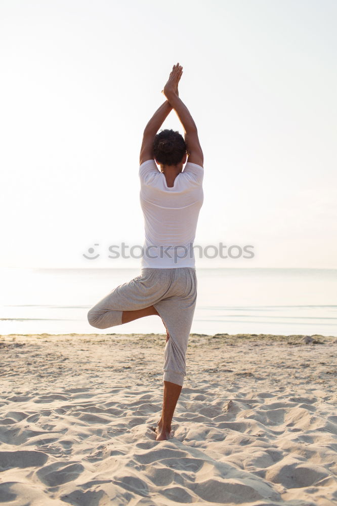 Similar – Rear view of young black woman doing yoga in the beach