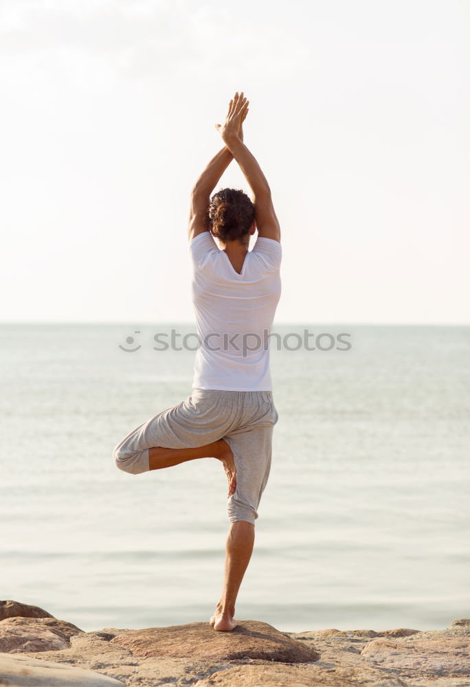 Similar – Rear view of young black woman doing yoga in the beach