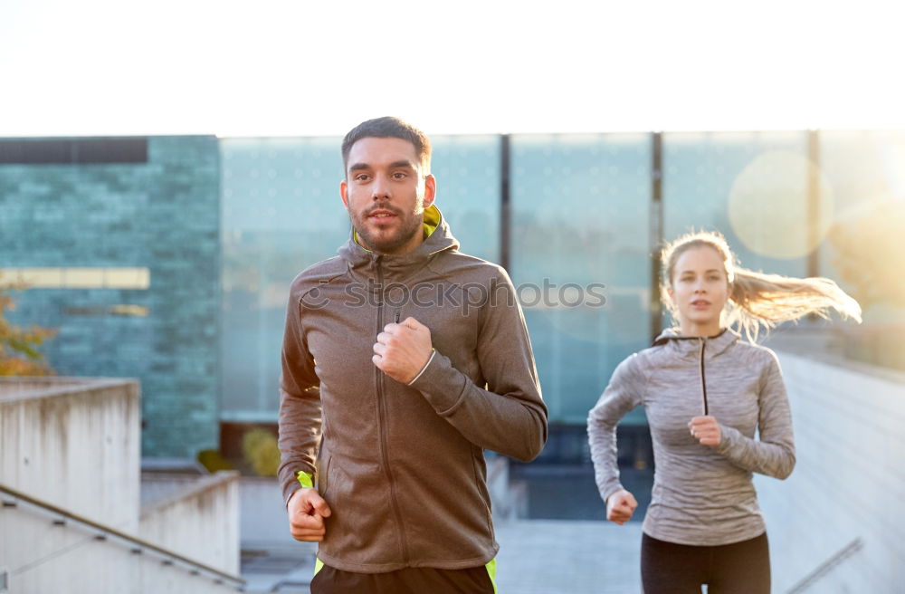 Similar – Active young couple jogging side by side in an urban street