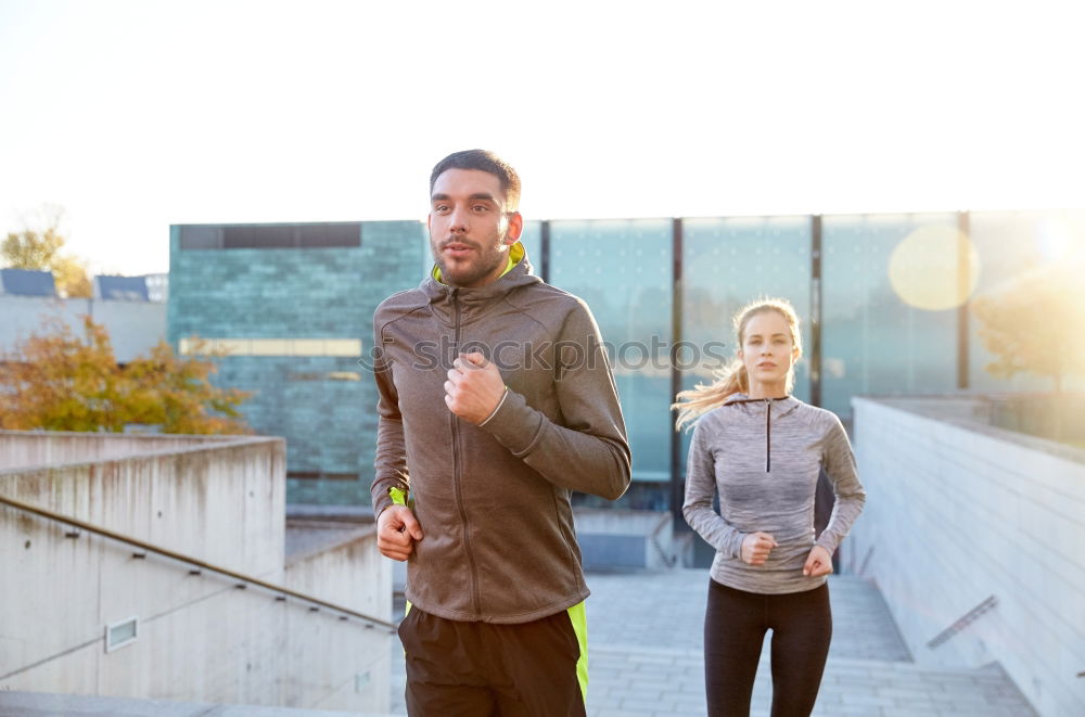 Similar – Active young couple jogging side by side in an urban street