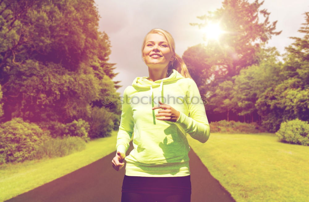 Pretty Woman Jogging at the Park with Headphones