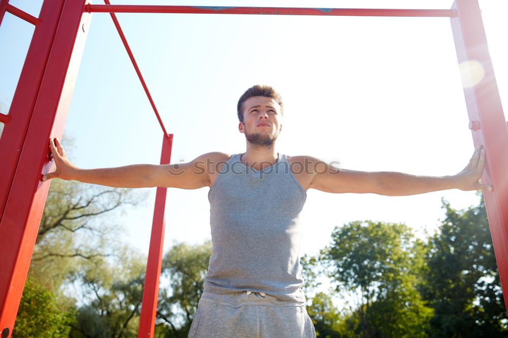 Similar – Athletischer junger Mann beim Vorbereiten und Kontrollieren von Gymnastikringen