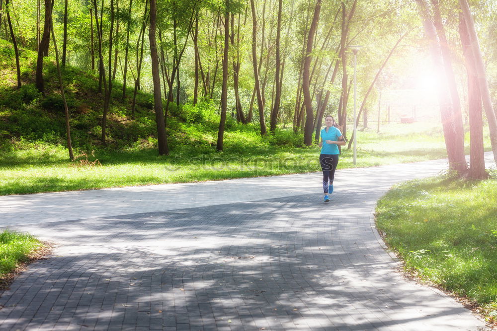 Similar – Image, Stock Photo Athletic young woman jogging along a forest track
