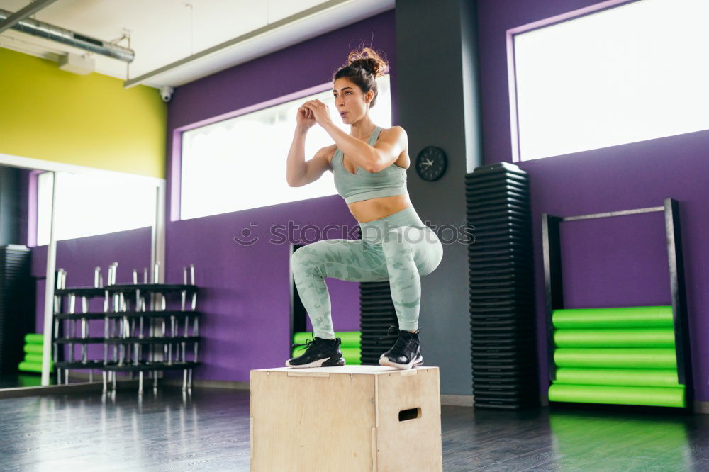 Smiling girl drinking in gym