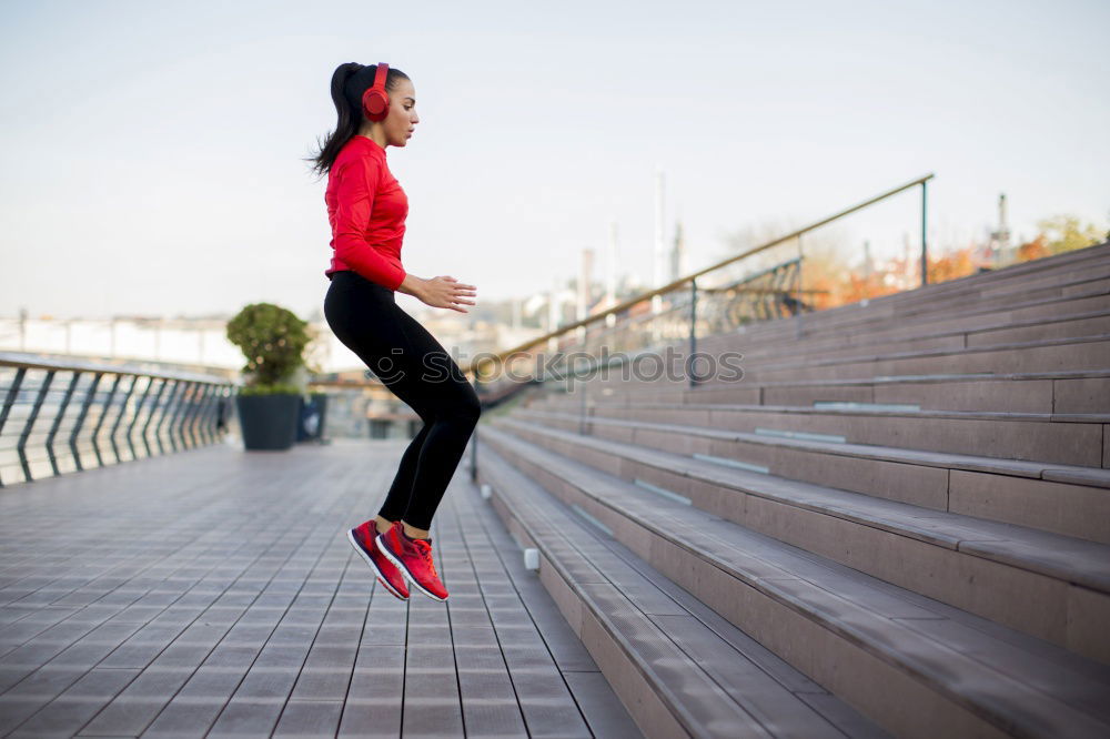 Similar – Young fitness woman runner running on city bridge.