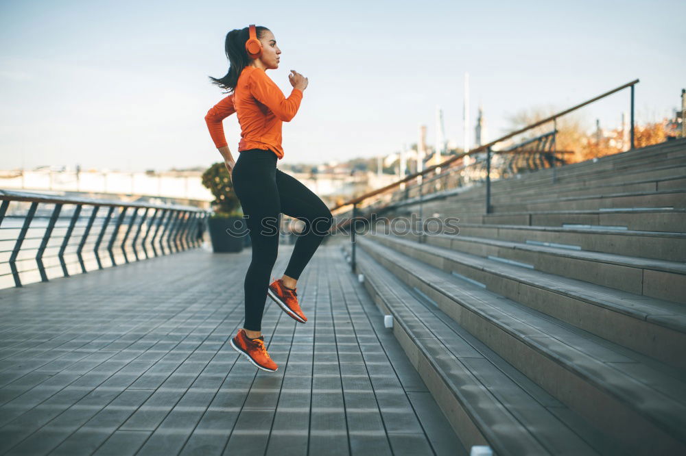 Female young athlete doing interval training on stairs