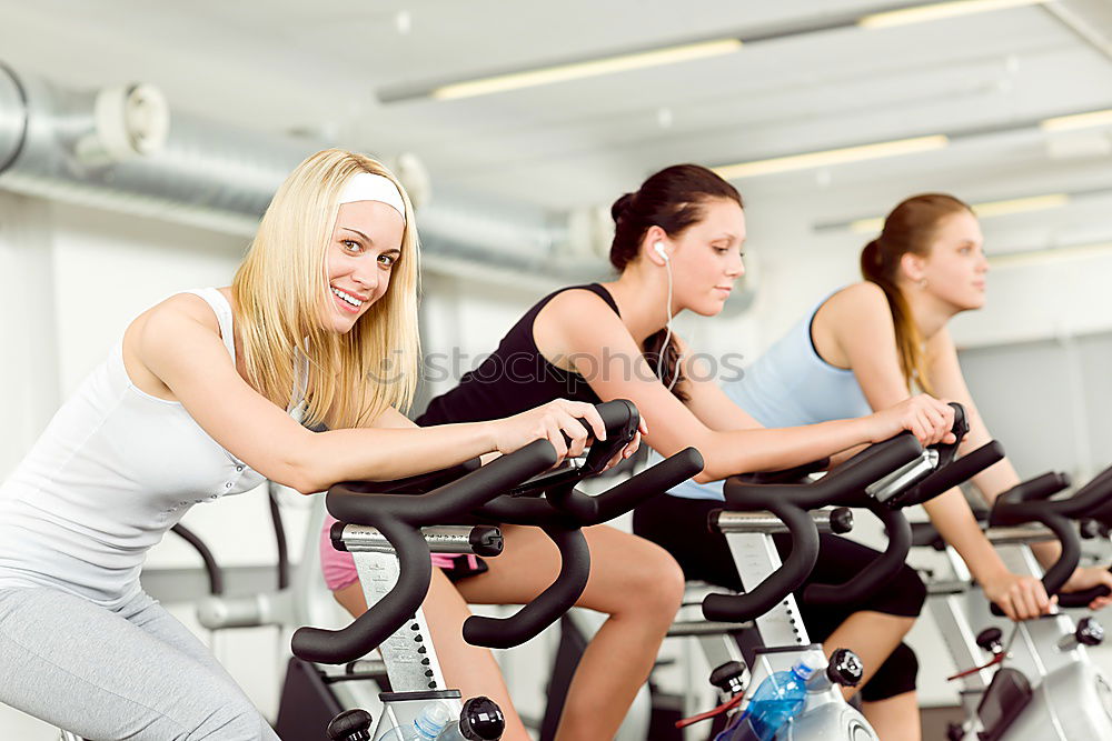 Similar – Concentrated woman in hard bike training session