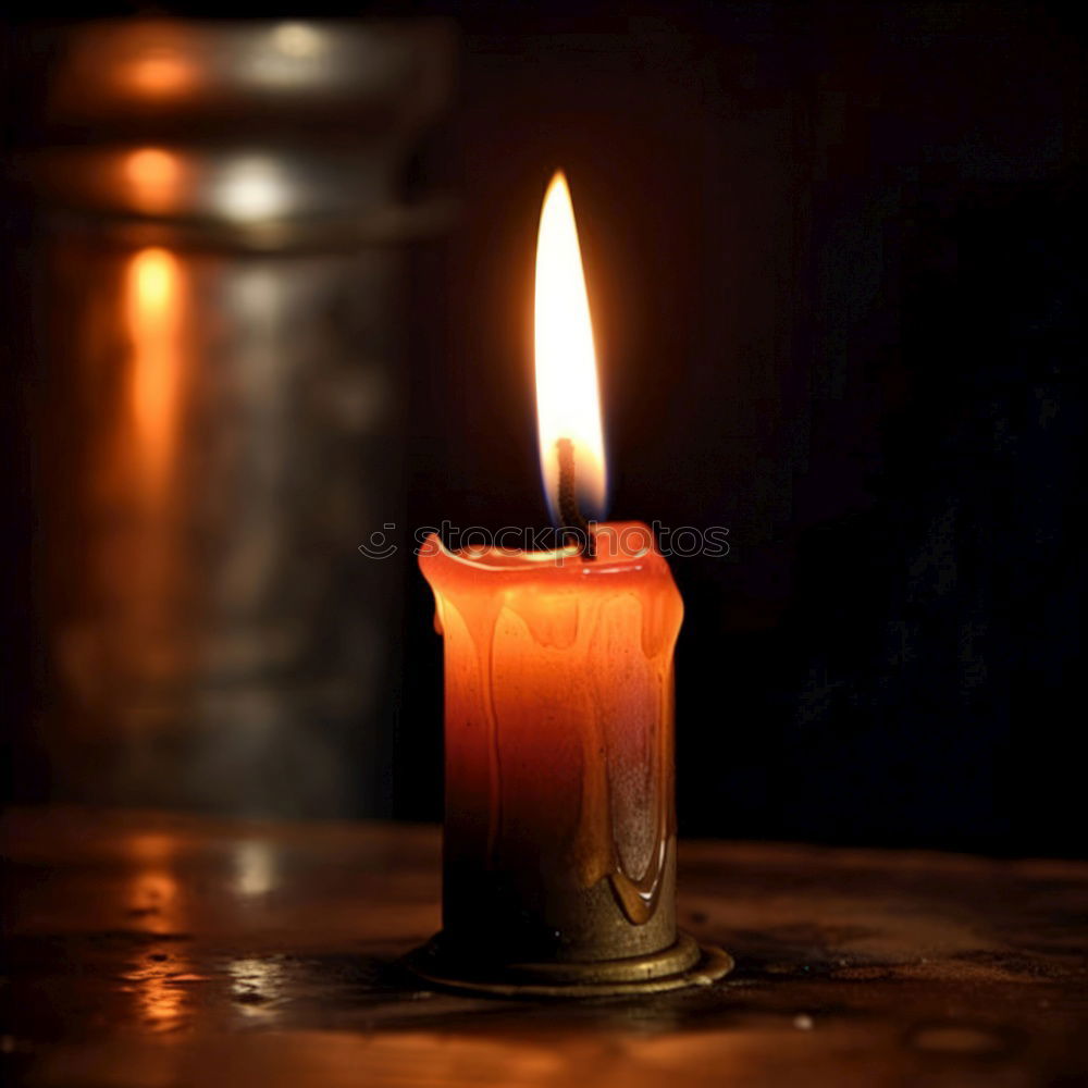 A single red burning candle held by a girl