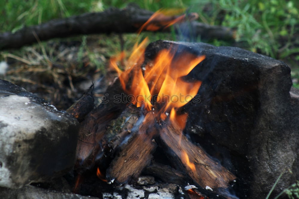 Similar – Ein großer Kochtopf hängt über offenem Feuer einer Feuerschale.