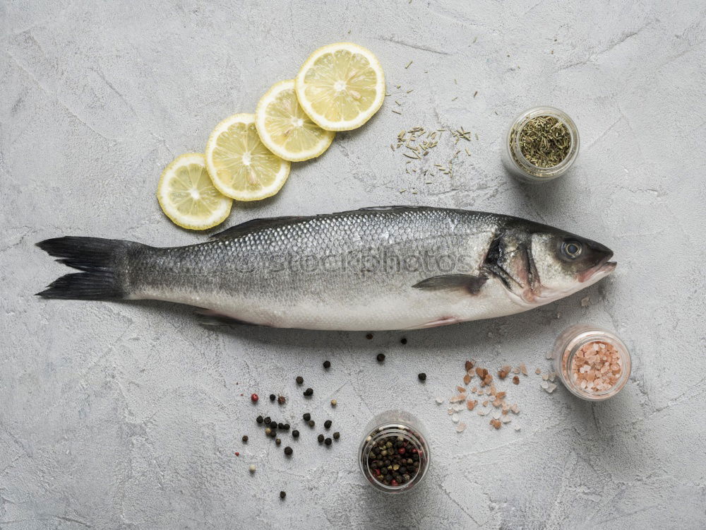 Similar – Image, Stock Photo Sea bass on kitchen table with lemon and rosemary