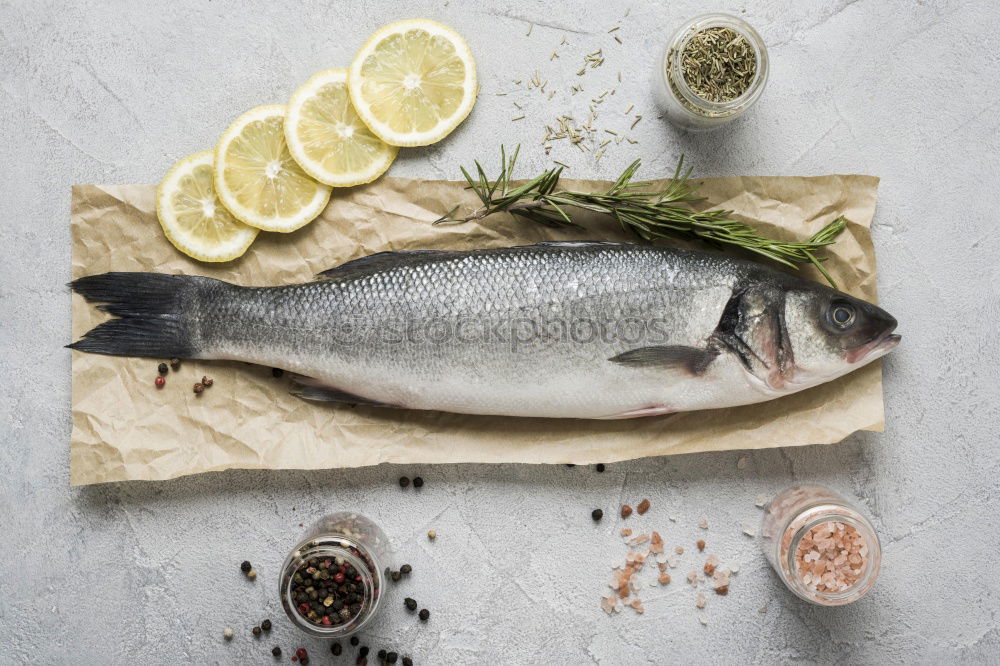 Similar – Image, Stock Photo Sea bass on kitchen table with lemon and rosemary