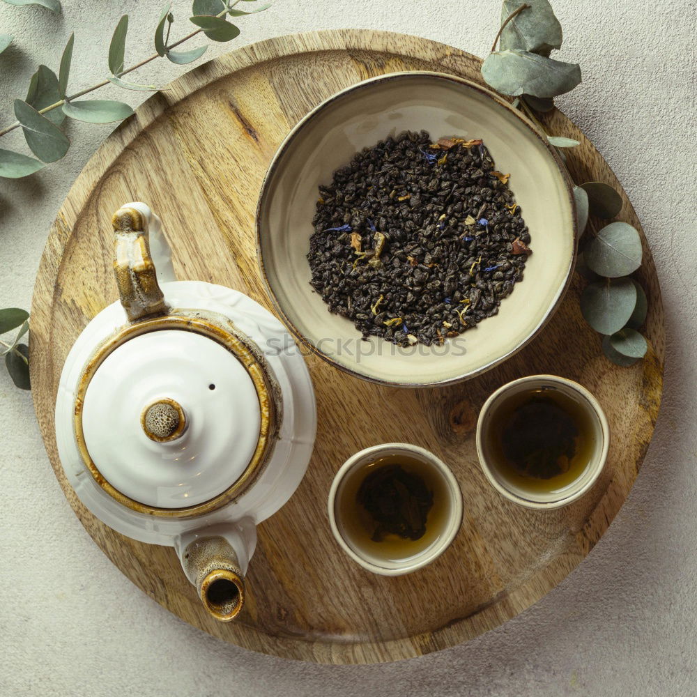 Black tea with jasmine in a white cup on a brown wooden table