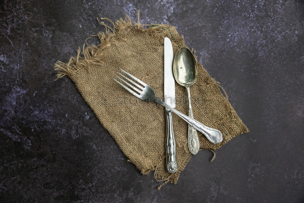 Similar – cutlery on the gray wooden surface