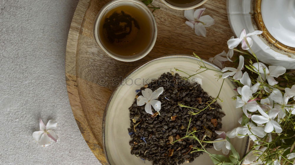 Similar – Black tea with jasmine in a white cup on a brown wooden table