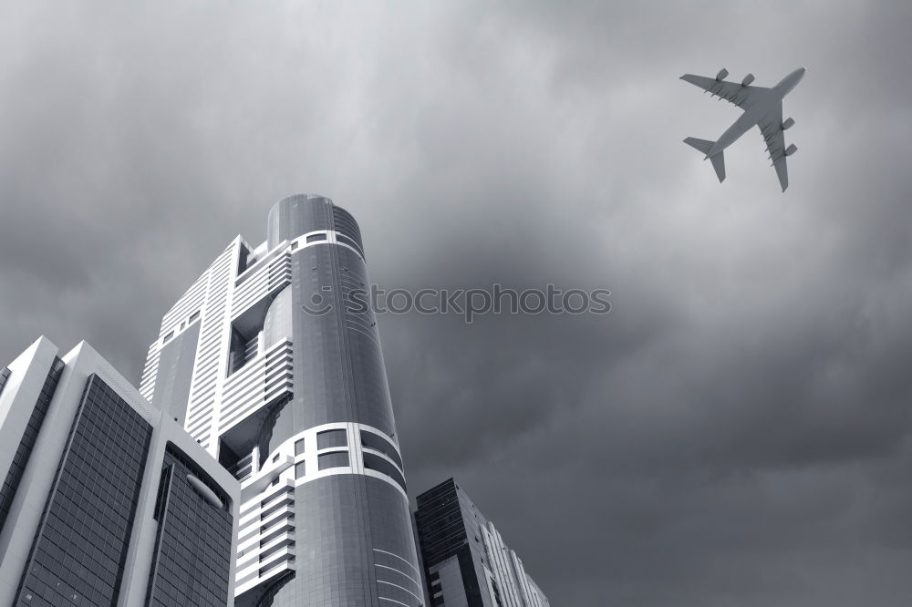 Similar – Plane flying over building