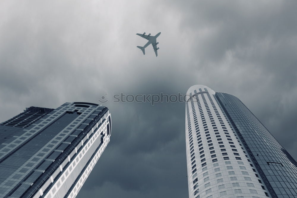 Similar – Plane flying over building