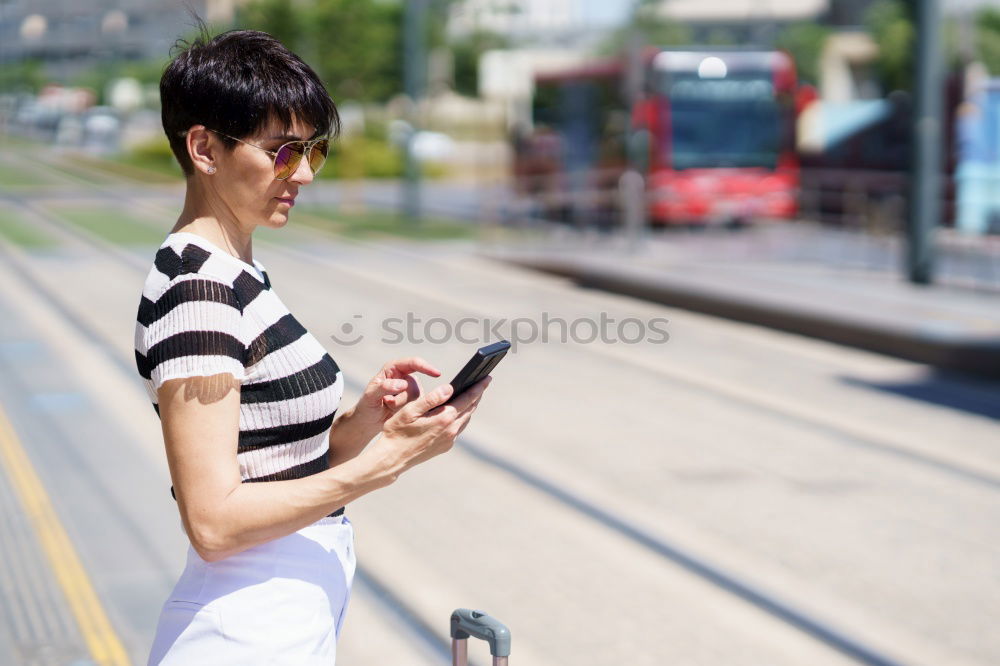 Similar – Image, Stock Photo Young woman with mobile phone at train station