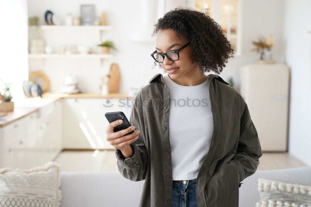 Similar – smiling young woman typing a message on cellphone