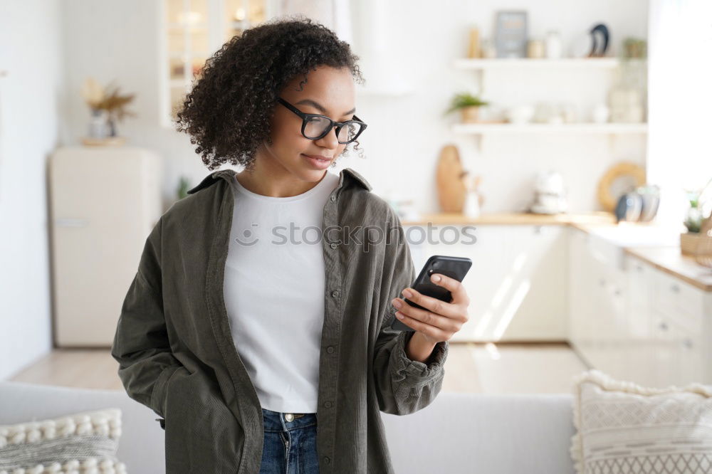 Similar – smiling young woman typing a message on cellphone