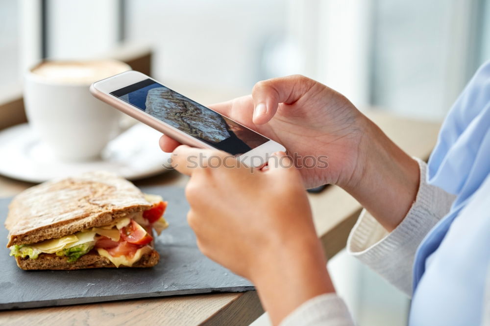 Similar – Image, Stock Photo Hand with smartphone mobile phone, photo of Burger on table